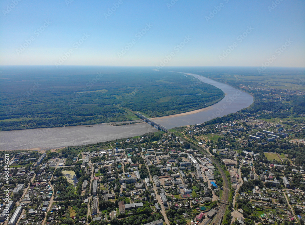 Aerial view of the city, Vyatka river and railway bridge (Kotelnich, Kirov region, Russia)