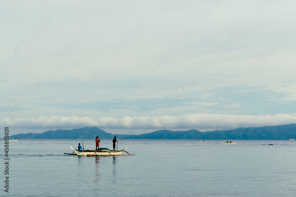 Volcano gas cloud eruption of Taal volcano watched by traditional banka boat fishermen. Aninuan beach, Philippines, September 2021