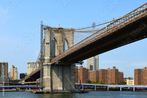 Brooklyn Bridge (1883), hybrid cable-stayed, suspension bridge, against blue sky in New York City. United States