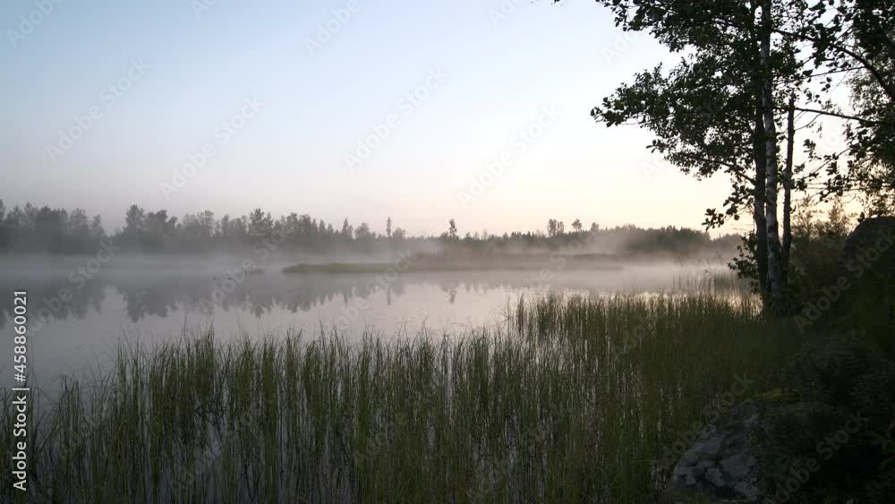 Amazing landscape with fog on misty lake at sunrise. Static view Amazing landscape with fog on misty lake at sunrise. Static view