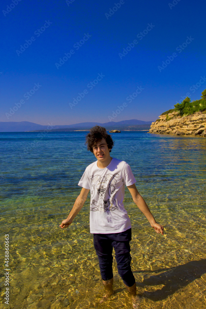  young man standing on the beach in summer