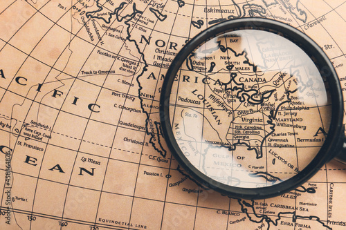 Magnifier on vintage world map