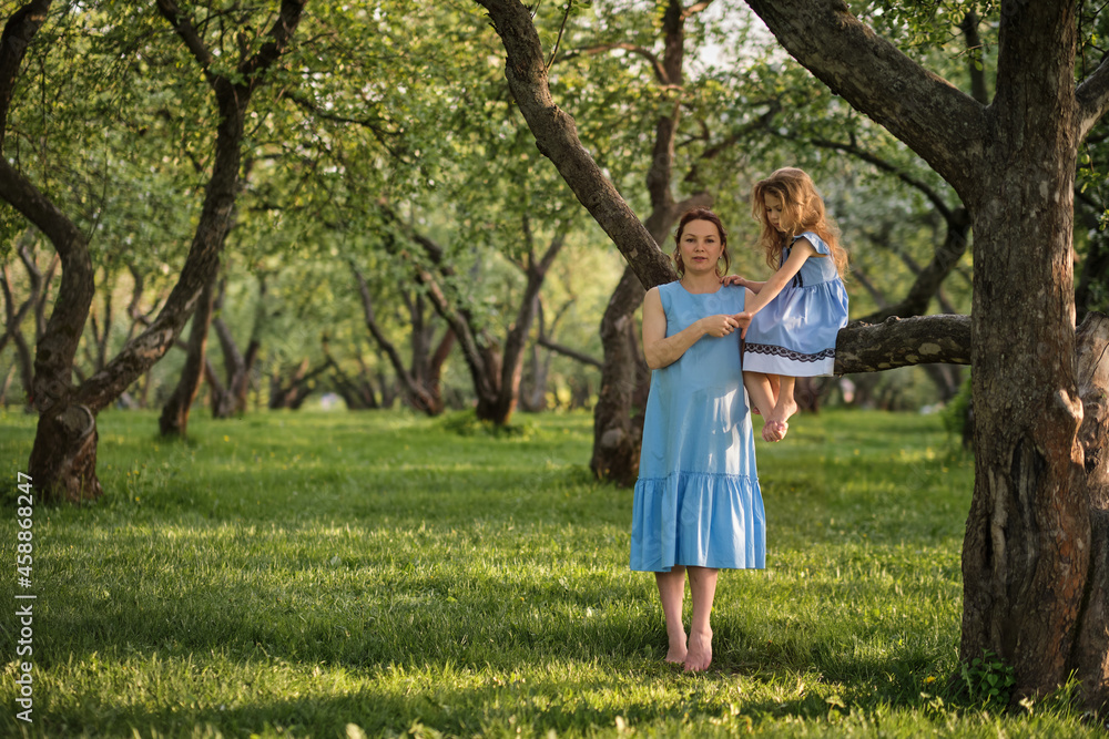 mother and child having fun in the park. Mother and little daughter playing together in a park. Happy family concept.