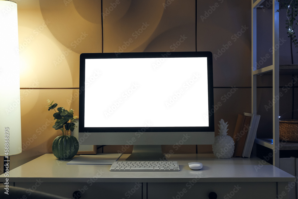 Fototapeta premium Modern workplace with computer in dark room