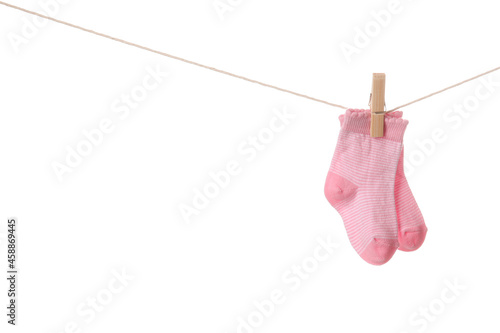 Baby socks hanging on rope against white background © Pixel-Shot