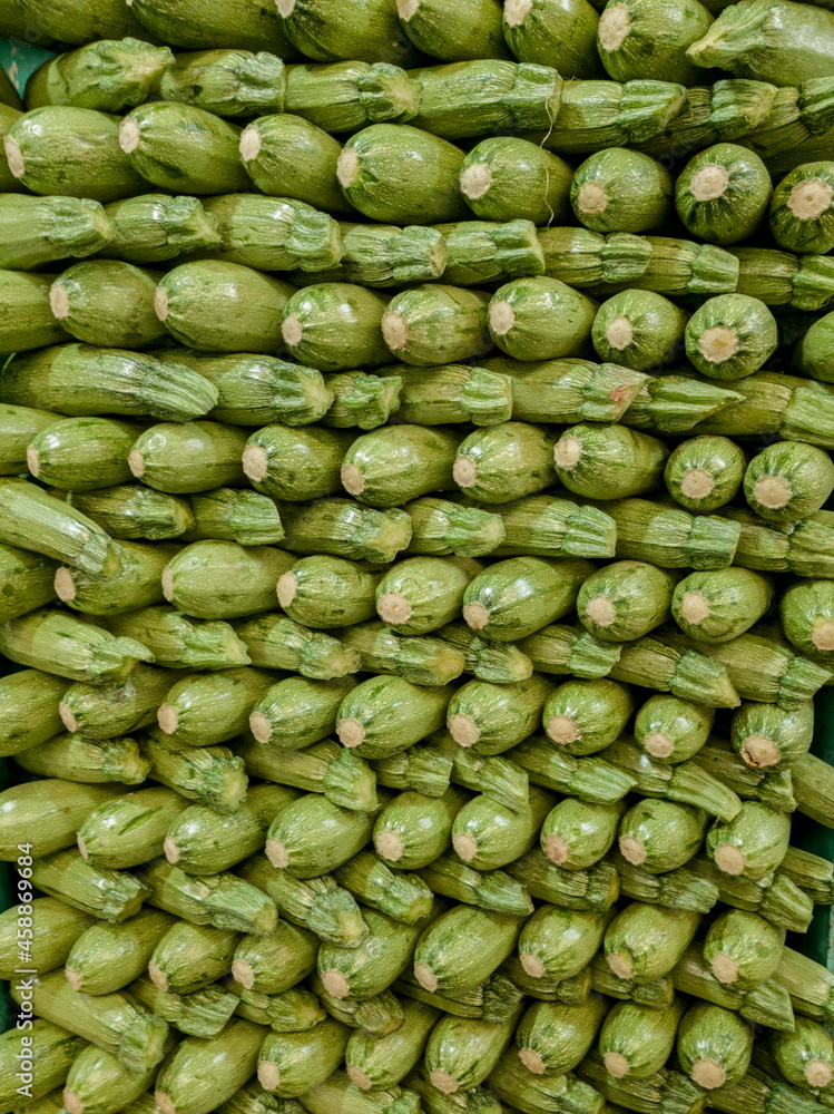 stacked zucchini displayed for sale in market stacked zucchini displayed for sale in market