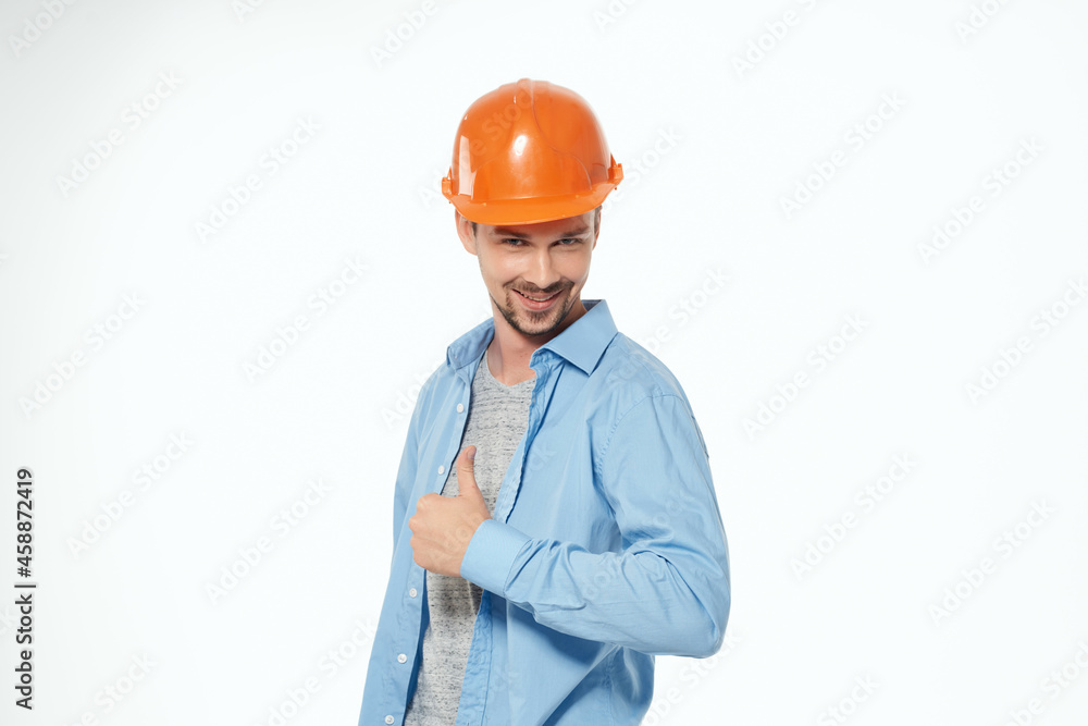 man in orange hard hat construction safety work light background man in orange hard hat construction safety work light background
