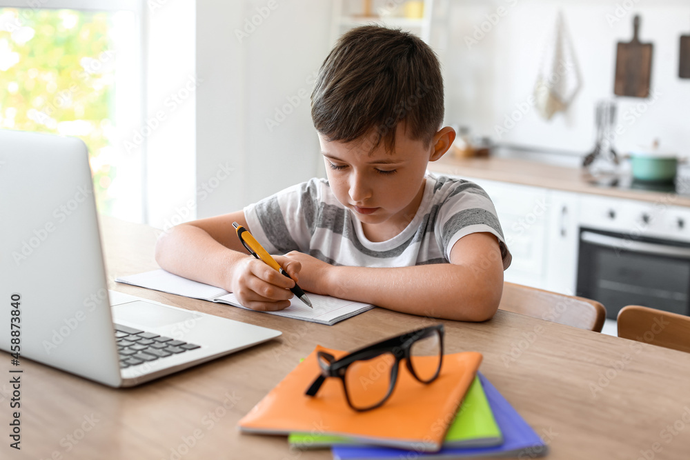 Little boy doing homework in room Little boy doing homework in room
