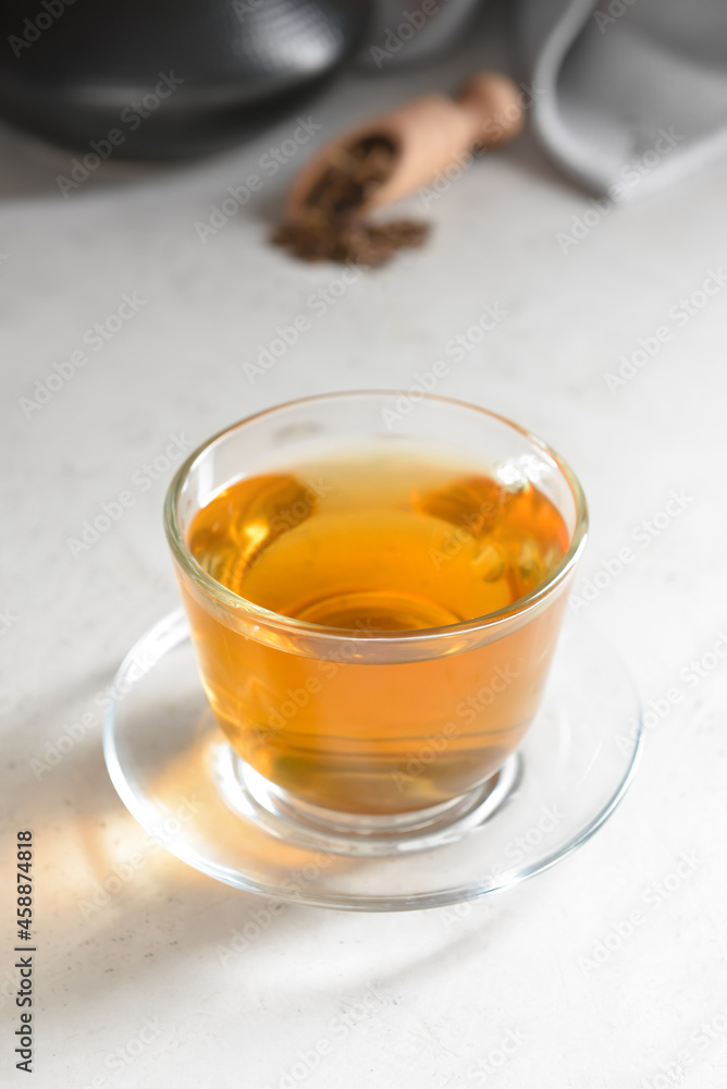 Cup of tasty hojicha green tea on light background Cup of tasty hojicha green tea on light background