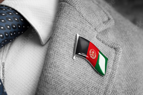 Metal badge with the flag of Afghanistan on a suit lapel photo