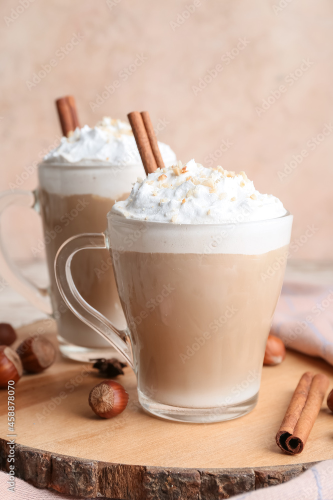 Glass cups of tasty latte with nuts on table Glass cups of tasty latte with nuts on table