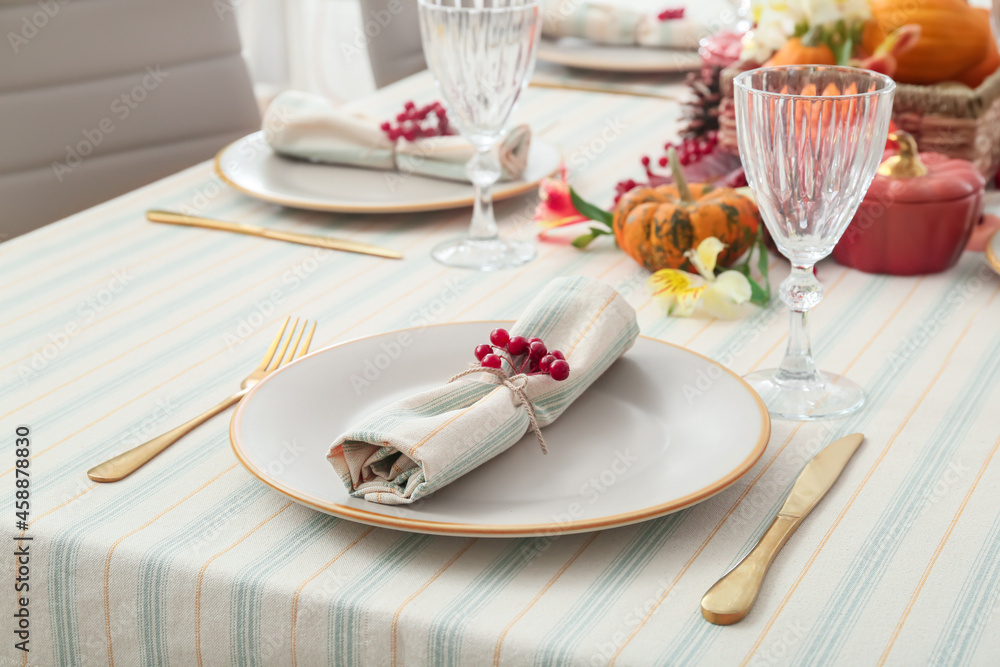 Autumn table serving with rowan, cutlery and glass in restaurant Autumn table serving with rowan, cutlery and glass in restaurant