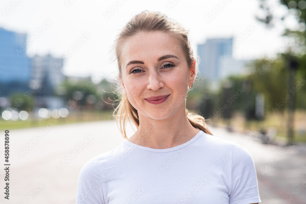 Portrait of a young, happy and attractive blonde Caucasian girl.