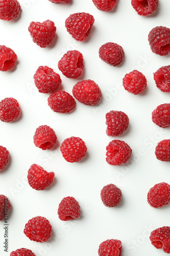 Flat lay composition with red juicy raspberries on a white background