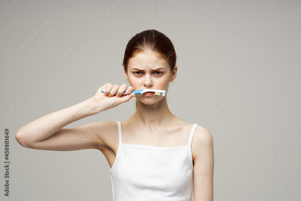 woman with a toothbrush in hand morning hygiene studio lifestyle woman with a toothbrush in hand morning hygiene studio lifestyle