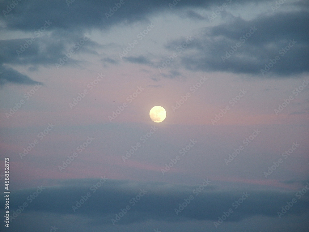 The moon in a red sky sunset