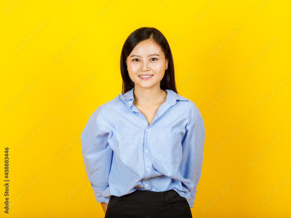 Portrait of young and cute Chinese, Japanese style woman pose to camera with positive gesture and friendly smile on yellow camera Portrait of young and cute Chinese, Japanese style woman pose to camera with positive gesture and friendly smile on yellow camera