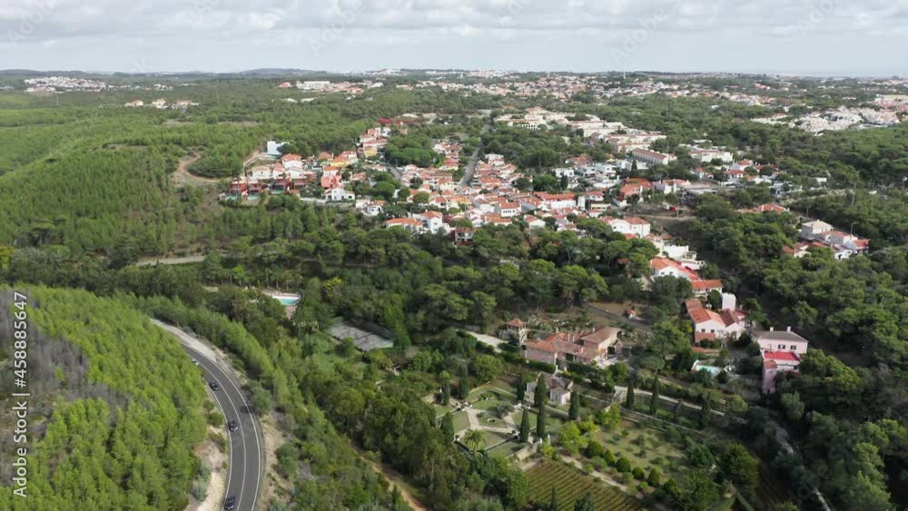 Scenery shot of Cascais city surrounded woods, Portugal, Europe. Drone shot of green landscape with forest and city houses. Cars driving on highway in mountains at cloudy day , 4k footage Scenery shot of Cascais city surrounded woods, Portugal, Europe. Drone shot of green landscape with forest and city houses. Cars driving on highway in mountains at cloudy day , 4k footage