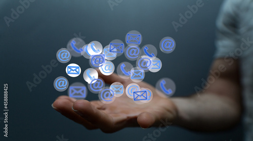 Hand holding using mobile phone with email icon on screen. Concept of business communication