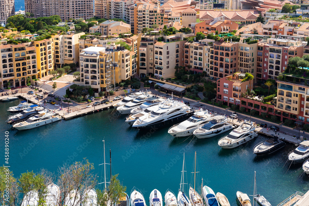 Scenic aerial view on luxury yachts and apartments of city centre and harbour of Monte Carlo, Cote d'Azur, Monaco, French Riviera.