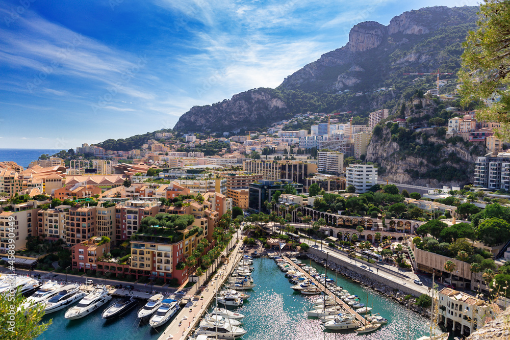 Scenic view on luxury yachts and apartments of city centre and harbour of Monte Carlo, Cote d'Azur, Monaco, French Riviera.