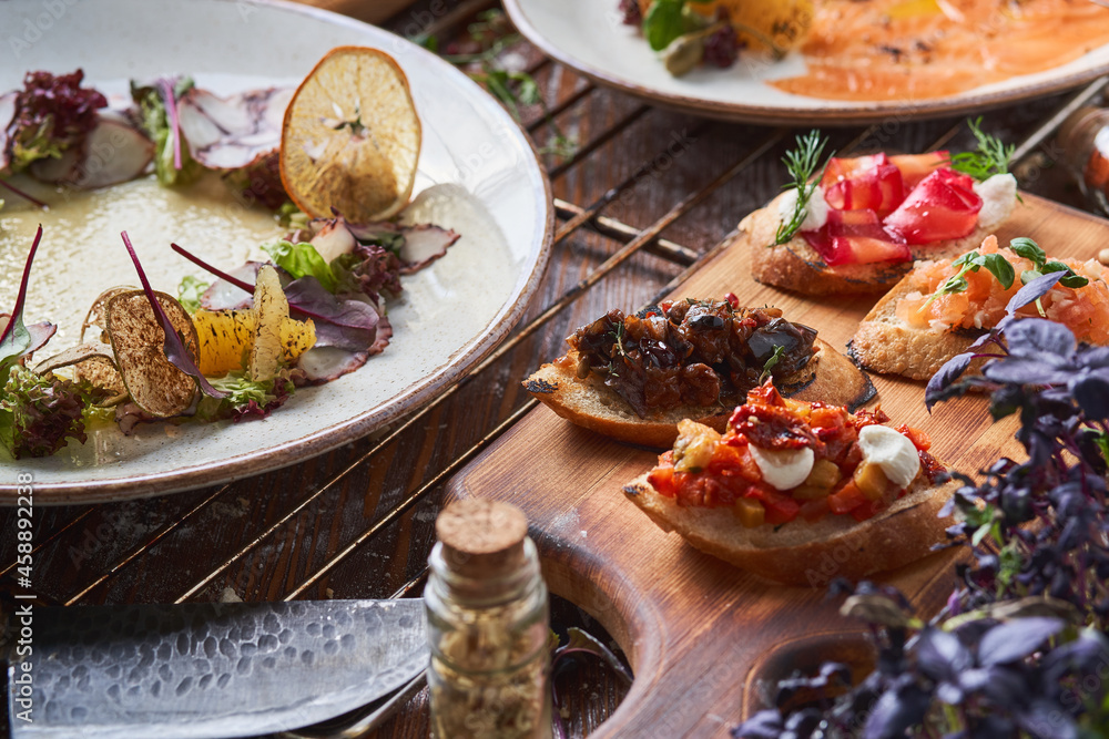 Italian food on the table. Carpaccio, bruschetta, cheese, seafood Italian food on the table. Carpaccio, bruschetta, cheese, seafood