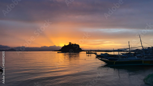 Glorious sunset from a fishing village at Gigantes Island, Philippines photo