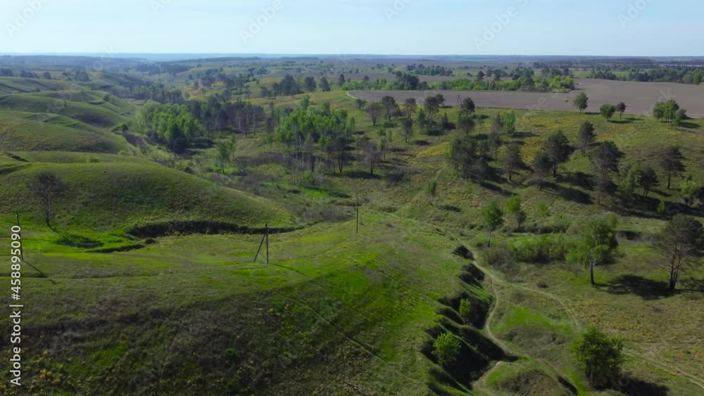 Valley with ravines on slopes in sptingtime, aerial view Valley with ravines on slopes in sptingtime, aerial view