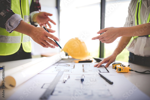 architect concept, working architect with blueprints in office to present to customers