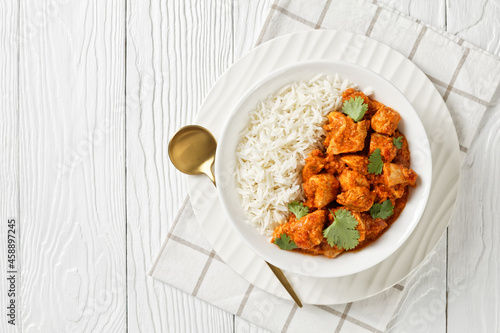 butter chicken, curry of spicy chicken with rice photo