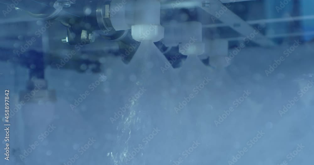 jets of clean, transparent water flow from pipes to the washing chamber.close-up. jets of clean, transparent water flow from pipes to the washing chamber.close-up.