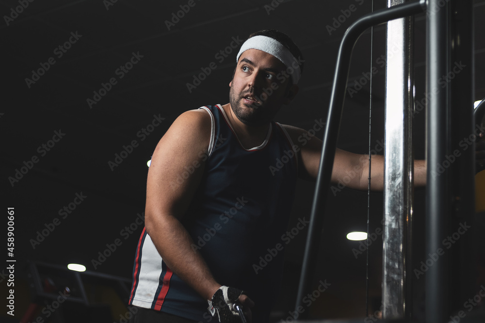 a funny fat boy doing sports inside a gym.
overcoming concept.
willpower. a funny fat boy doing sports inside a gym.
overcoming concept.
willpower.