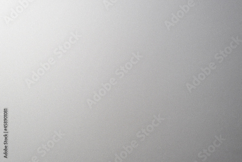 Matte gray smooth plastic surface with fine texture and vignette on the right side. Exquisite textured background, soft blank backdrop photo
