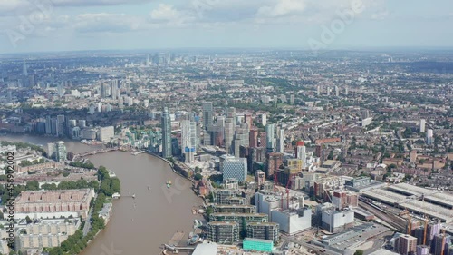 Wallpaper Mural Backwards fly high above city. Modern residential building at bank of Thames river. Panoramic aerial view of large town. London, UK Torontodigital.ca