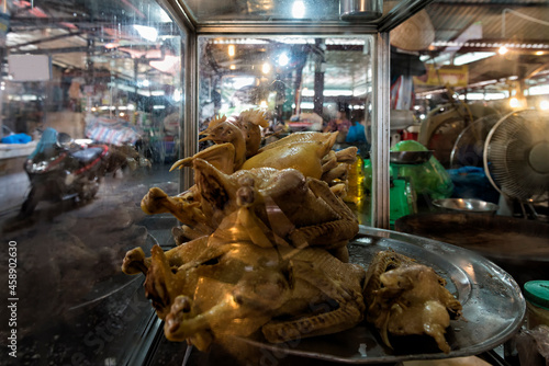 Display with whole roasted chickens in the food market in Hanoi