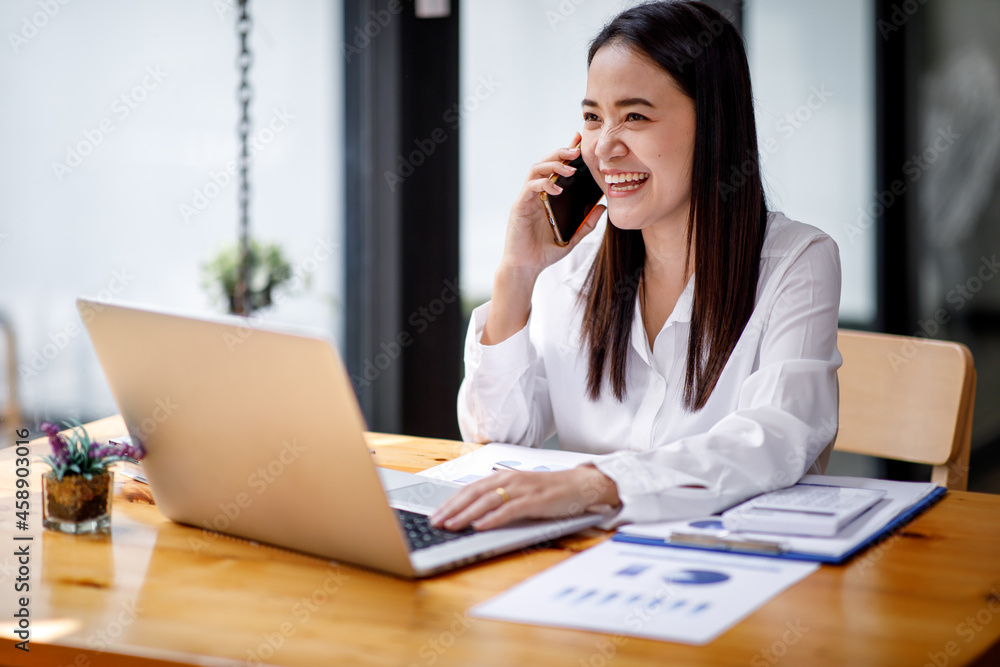 Portrait of Accounting businesswoman working on note laptop computer and analyzing real estate investment data, Financial and tax systems concept. Portrait of Accounting businesswoman working on note laptop computer and analyzing real estate investment data, Financial and tax systems concept.
