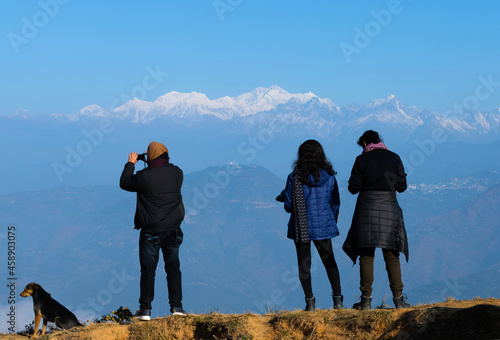 Tourists enjoying the view of snowy Himalayan Mountain Mt. Kanchenjunga from Tinchuley near Darjeeling. photo
