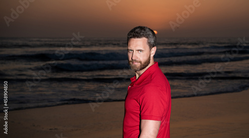 charismativ man portrait over the sea on sunset summer beach, summertime