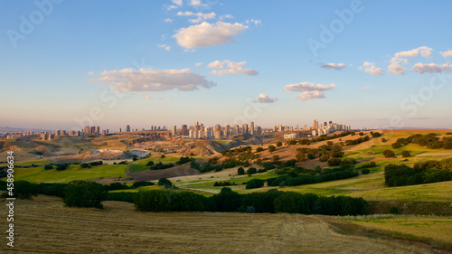 City view from the countryside in the evening. Distant city silhouette.