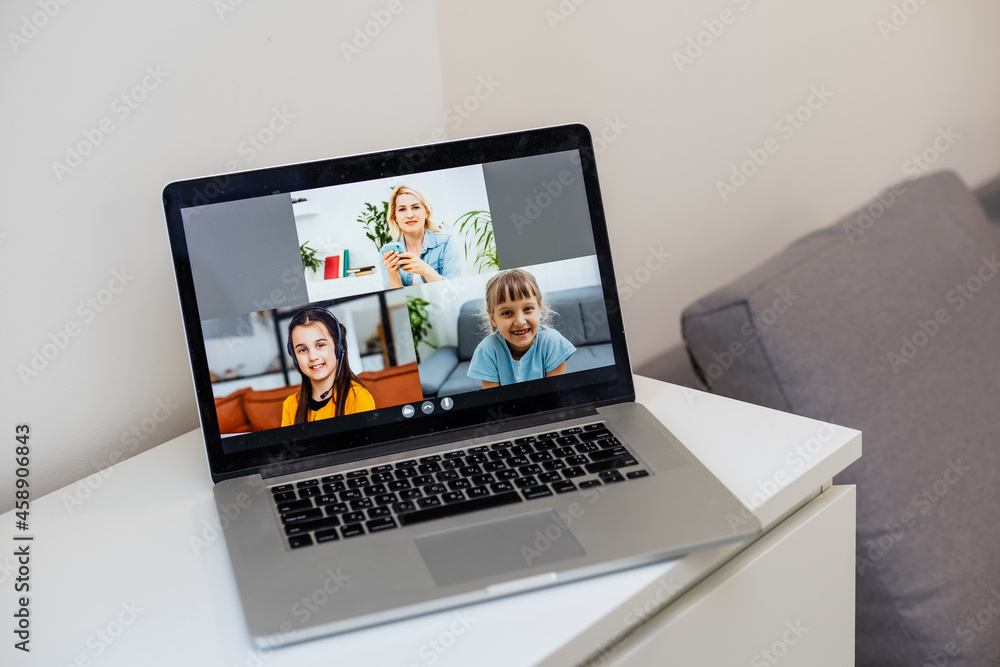 A Girl Video Conferencing With Happy Female Teacher On Laptop A Girl Video Conferencing With Happy Female Teacher On Laptop