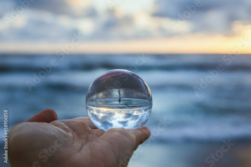 Magic sphere. Fortune teller  mind power concept. Crystal Ball reflecting water and sky.