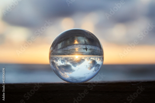 Fototapeta Naklejka Na Ścianę i Meble -  Magic sphere. Fortune teller, mind power concept. Crystal Ball reflecting water and sky.