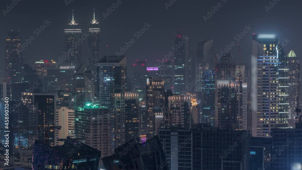 Skyline with modern architecture of Dubai business bay towers night timelapse. Aerial view