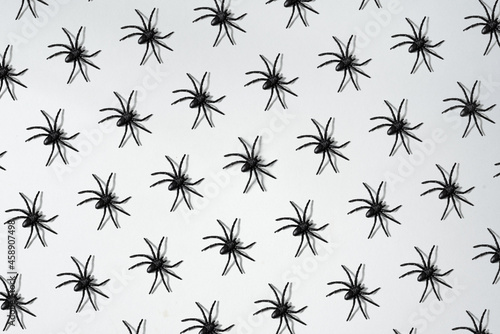 Pattern of big black tarantulas on white background. Decoration, texture for Halloween.