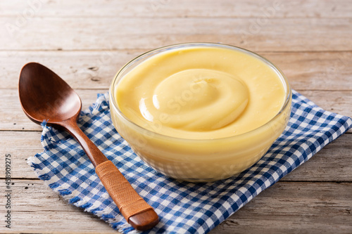 Fotobehang Pastry cream in a bowl on wooden table
