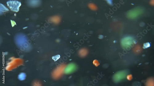 microplastics in water, tiny multicolored plastic bits. global ocean pollution - microplastic in water. recycling concept plastic background. single use plastics. microplastic pollution. photo