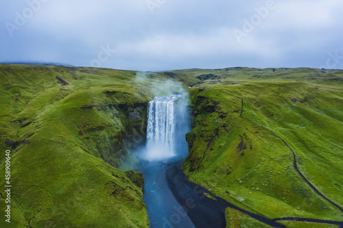 Aerial drone view of Skogafoss waterfall in Iceland  one of the most famous tourist visited attraction and landmark