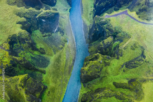 Aerial view of famous and unique Fjadrargljufur valley in Iceland on a rainy day in Iceland. Mossy cliffs and mountain river. Travel tourism destination