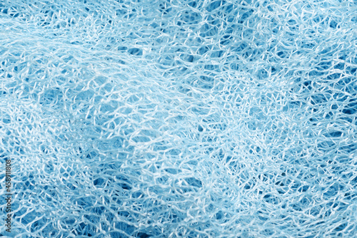 Close up of blue net knitted textured background. Trendy colors. © Svetlana Lavereva