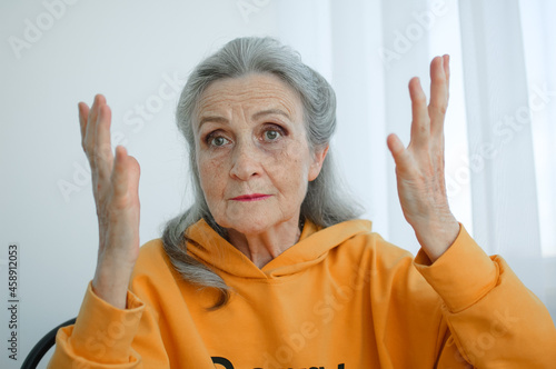 Closeup portrait of angry upset senior mature woman talking with someone and looking at the camera. Negative emotion, facial expression, scandal